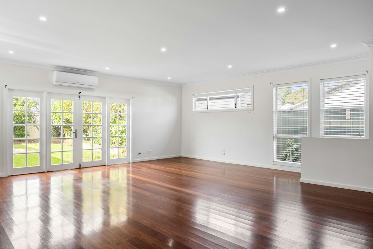 Finished hardwood living room: Unfurnished room · see the floor and natural light