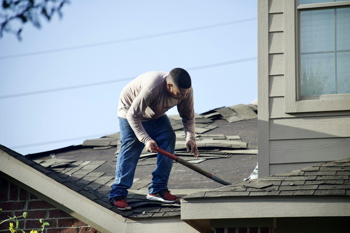 Roofing work in progress: Shingle removal before a roof replacement